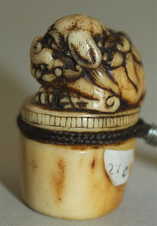 A Japanese stag antler netsuke of a shi-shi, Asakuso School, Edo period, 3.8cm